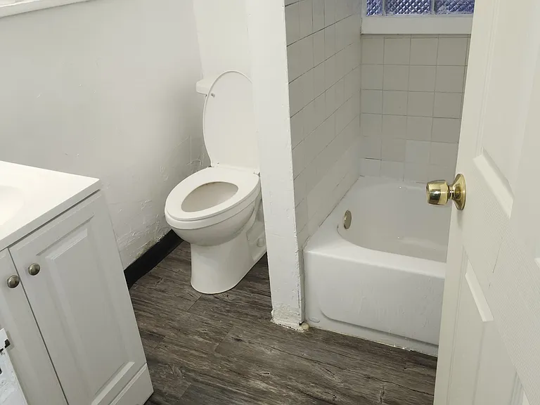 This is the bathroom. A new toilet, vanity and mirror were recently installed.