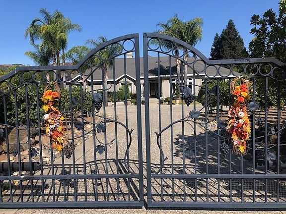 Front electric gated entrance to the property. The guesthouse is located at the rear of the property and has it's own concrete driveway and garage.