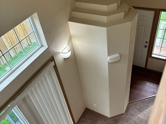 View from upstairs open hallway. Looking down to dining area and entry way