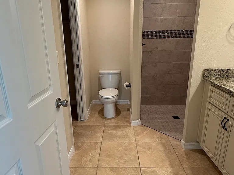 Mater bathroom has walk in shower and closet is part of bathroom.