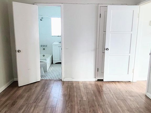 Large living room space with ceiling fan and comes with AC unit