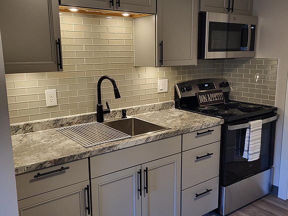 Brand new functional kitchen. Deep single well sink. New fridge, stove & microwave.