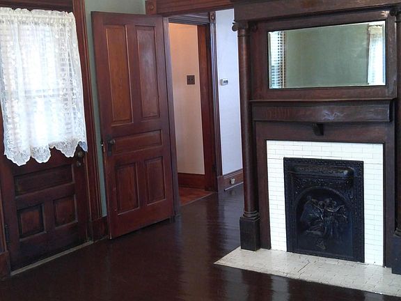Bright, bedroom with closet and hardwood floors.