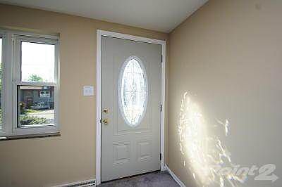 Entry door with leaded glass window.