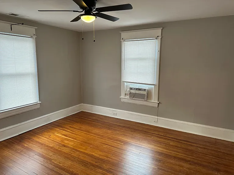 Bedroom One w/ Designer Ceiling Fan and Newly Refinished Hardwood Floors.