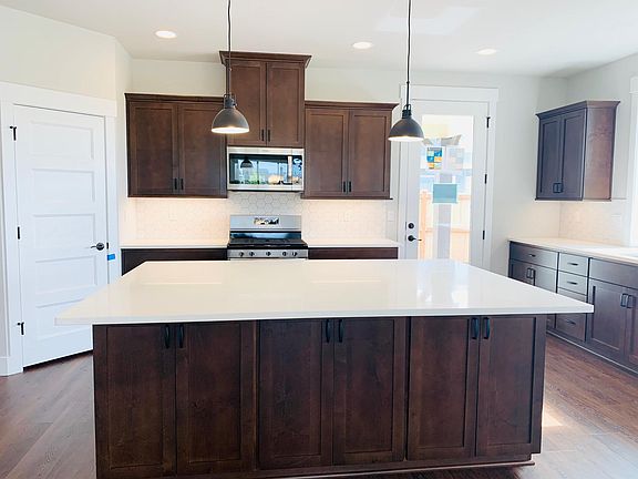 Kitchen with storage cabinets, pantry storage and Island.