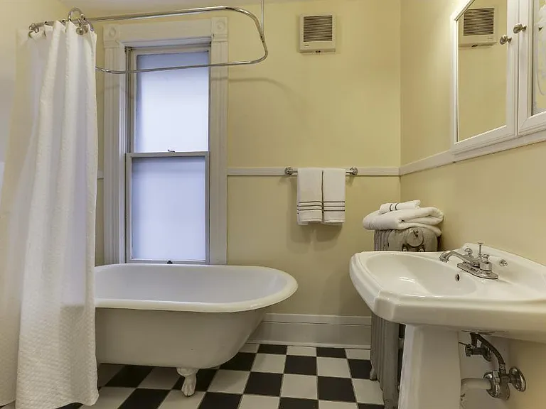 Bathroom with claw foot tub + shower