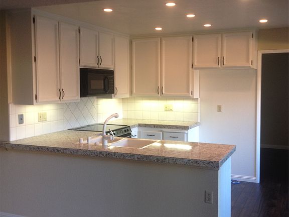 New granite tile countertops, freshly painted cabinets, glas