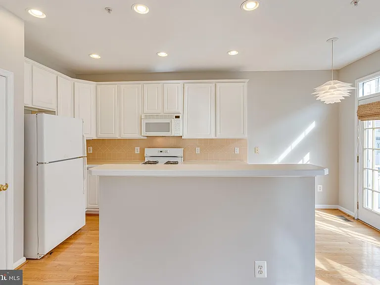 Kitchen with French doors and back balcony.