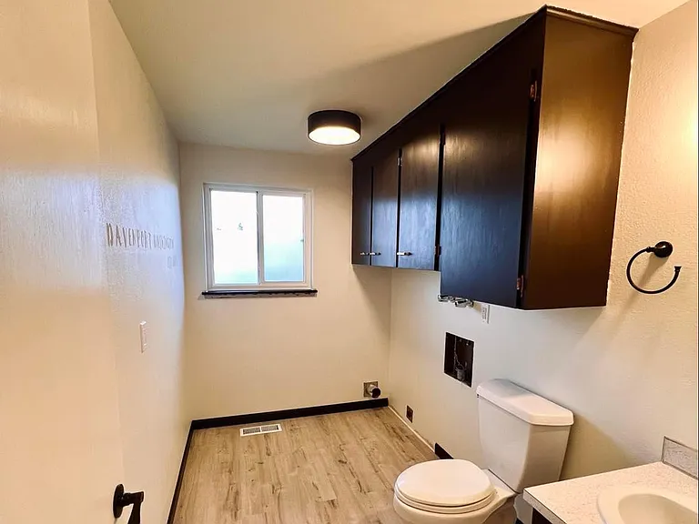 Laundry room. Gorgeous chocolate and ivory. New fixtures and new flooring throughout.