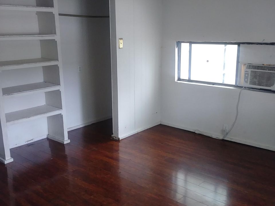 Rear bedroom with large closet and hardwood floors.