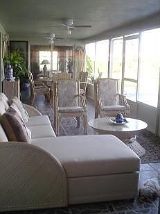 Back screened patio in front of pool