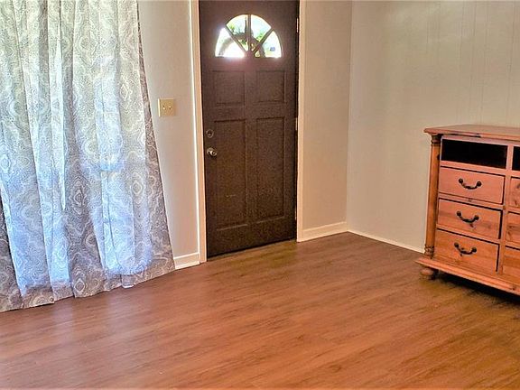 Spacious living room--Note the wood or laminate floors throughout.