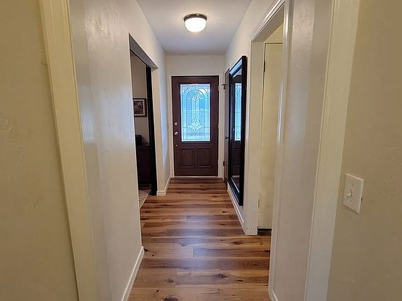Front entry. Flex room 1 to left, hallway to 4 bedrooms to right