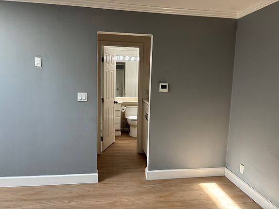 Private bath through a storage alcove.