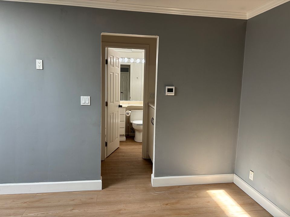 Private bath through a storage alcove.