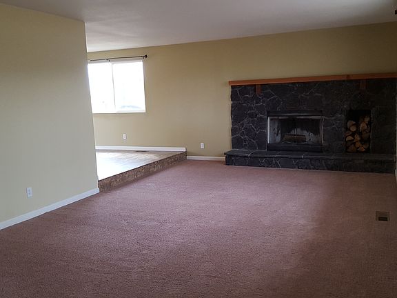 living room with wood burning fireplace