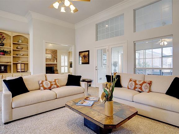 Front Living Area with Built In Cabinets and Wall of Windows!