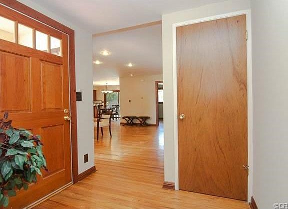 Formal entrance hall boasts a roomy coat closet and custom front