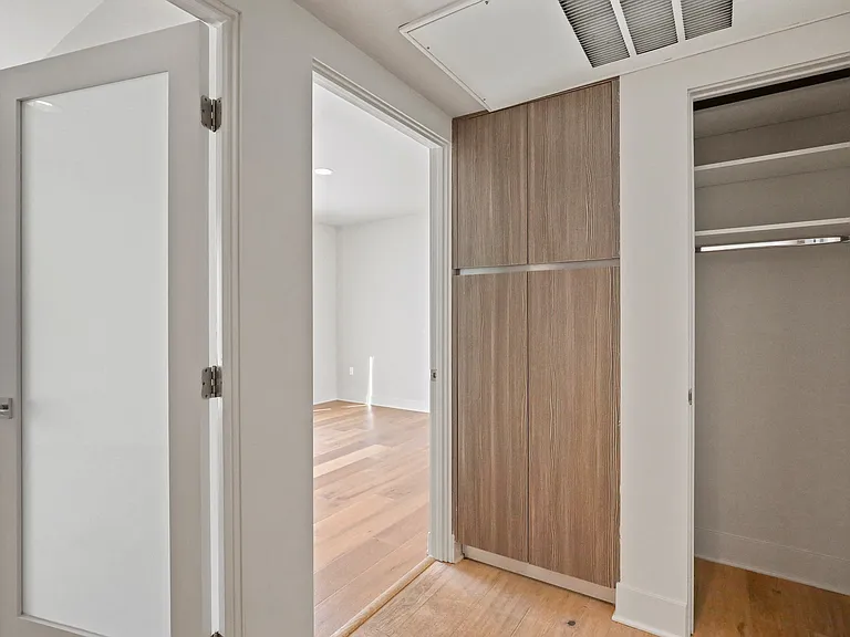Hallway with Coat Closet and Built-In Cabinet Storage