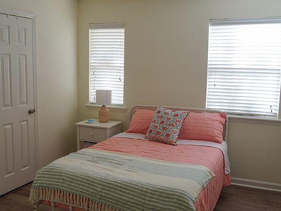Bedroom with Full-size bed, bathroom access, large closet space.