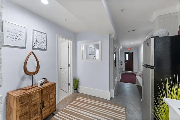 Welcoming shared hallway with decorative accents, durable flooring, and convenient access to bedrooms and common areas.