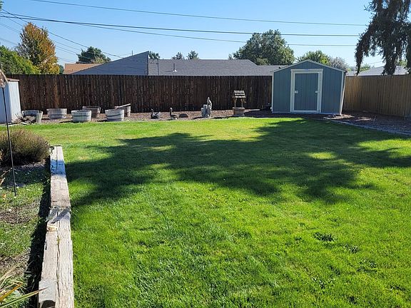 Large fenced backyard. Underground sprinklers and lawn mowing service provided.