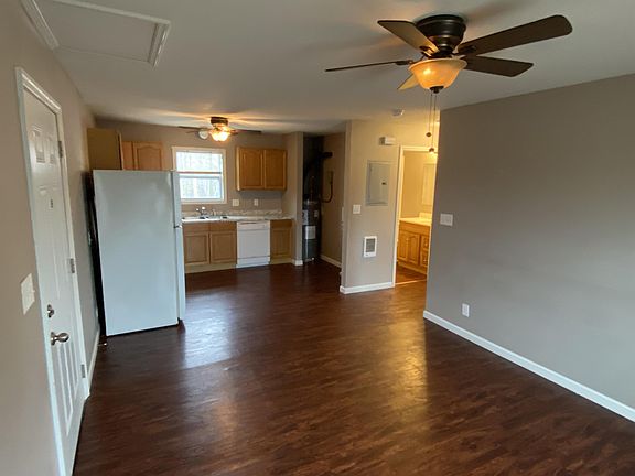 View of kitchen from the living room. Laundry location can be seen also.