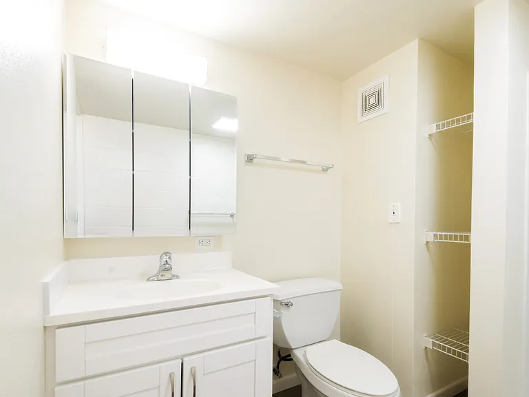 Bathroom featuring storage niche and modern fixtures.