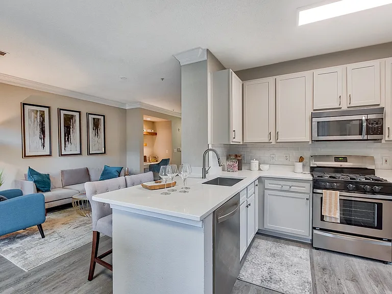 Stunning kitchens include quartz countertops and a breakfast bar.
