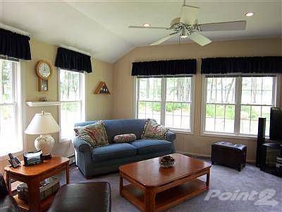 Family room with vaulted ceiling and ceiling fan