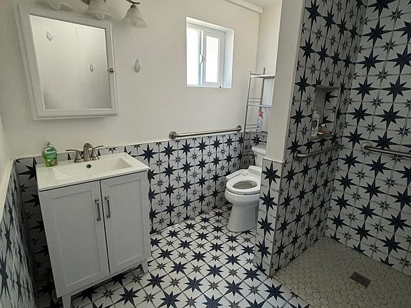 View of bathroom, vanity, medicine cabinet, sink and storage.