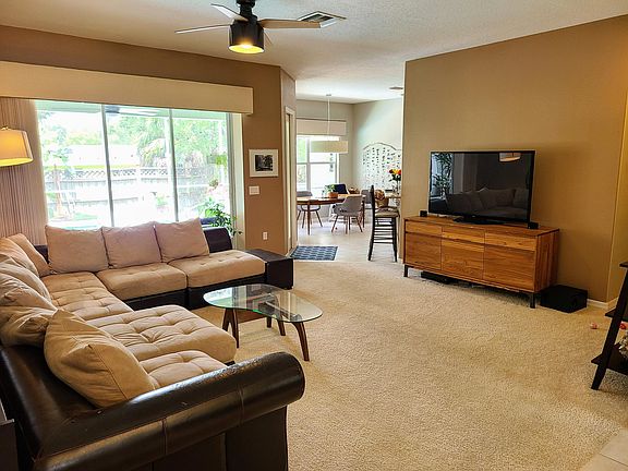 Living room opening to Lanai an pool.