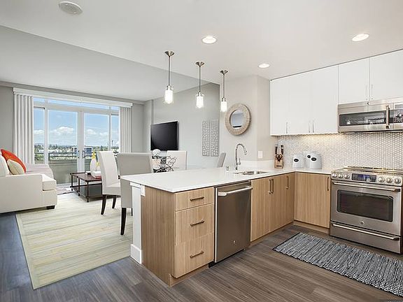Signature Collection Kitchen Living and Dining Area with Hard Surface Vinyl Plank Flooring