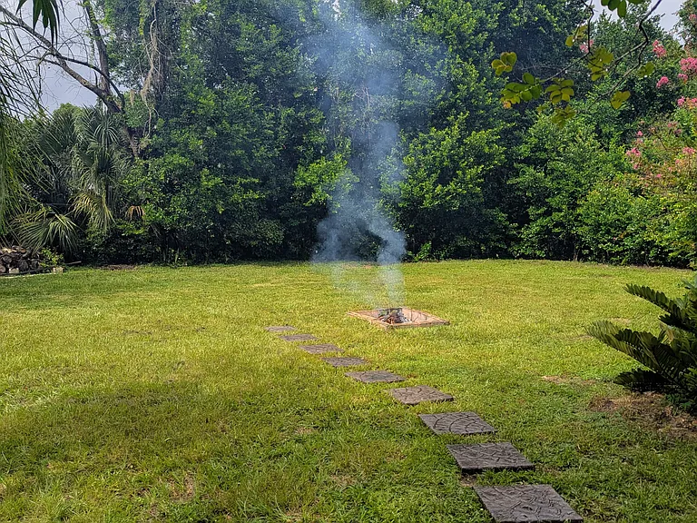Backyard with walkway to firepit