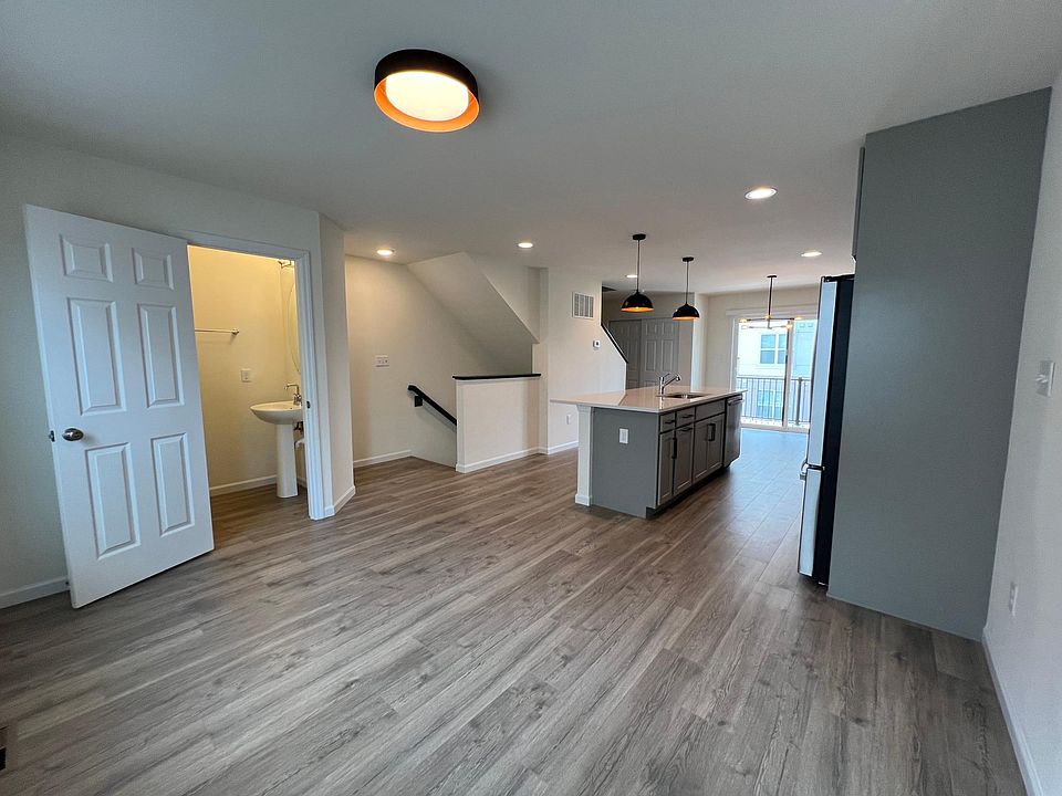 Living room and second floor bathroom with open concept living/kitchen space.