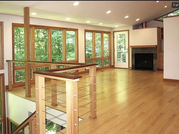 Open living room with gas fireplace and built-in bookshelves