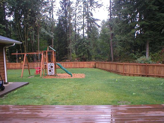 view from deck to large fenced in back yard