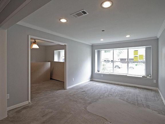 Front room with huge new window lets in a lot of natural light. This room could be used as a dining 