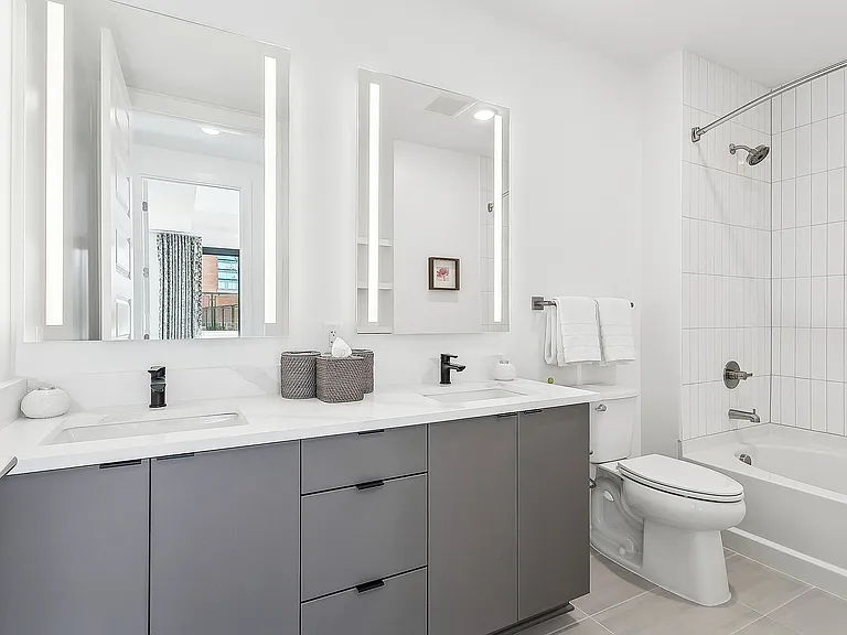 Spa bathrooms with double vanity sinks and sleek illuminated mirrors