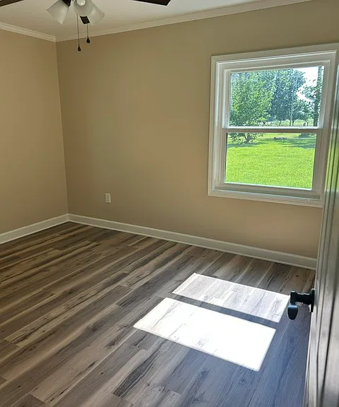 Primary Bedroom view from doorway of ensuite bathroom. Ceiling fan, Corner room with 2 windows providing lots of natural light.