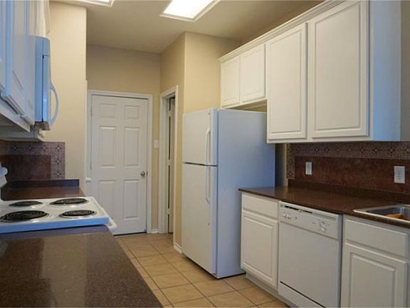 All matching white appliances & cabinetry along with beautiful granite counter tops