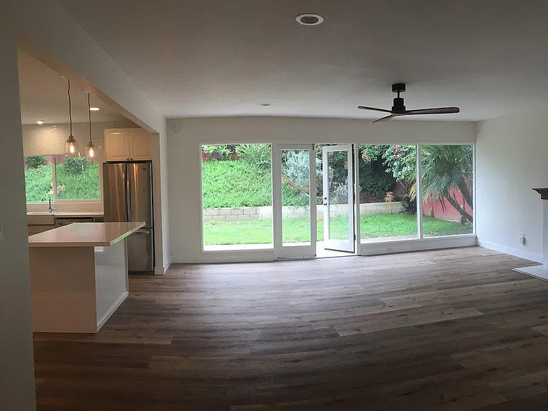 View of kitchen/living space from hallway/front door/Bedroom 1.