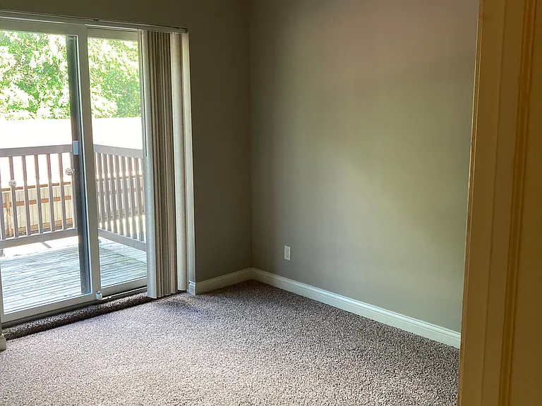BEDROOM WITH PATIO DOOR LEADING TO PRIVATE DECK