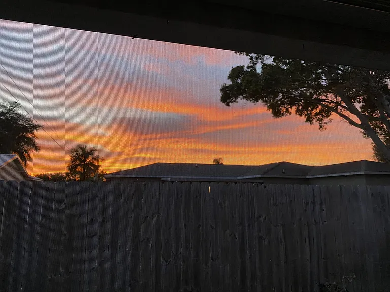 Sunset from the back screened-in patio. The house faces east/west so it gets great light and beautiful sunset views!