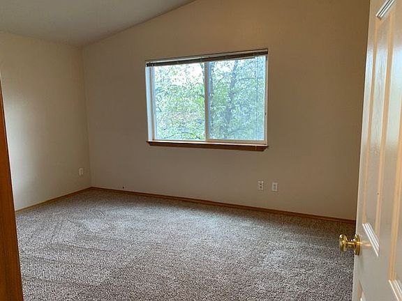 Large bedroom with vaulted ceilings, full bathroom and walk in closet.
