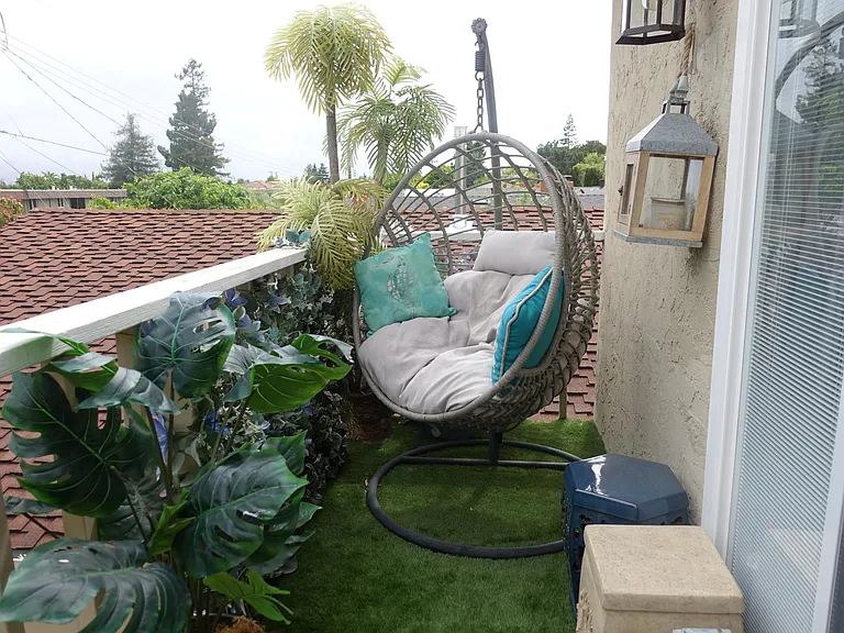 Balcony swing provides a paradise-like setting for relaxation.