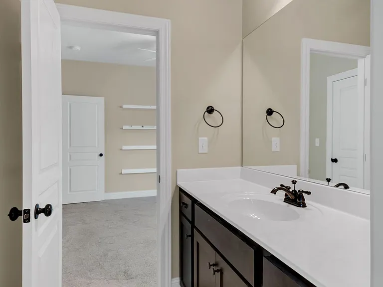 Jack and Jill bath connecting second and third bedrooms with separate vanity room