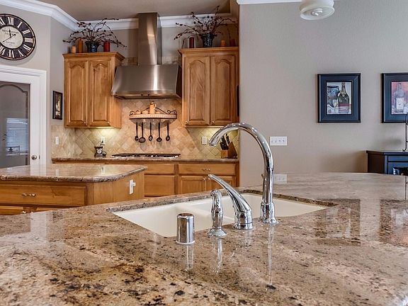 A walk-in pantry and gleaming stainless appliances add to the appeal of this kitchen...