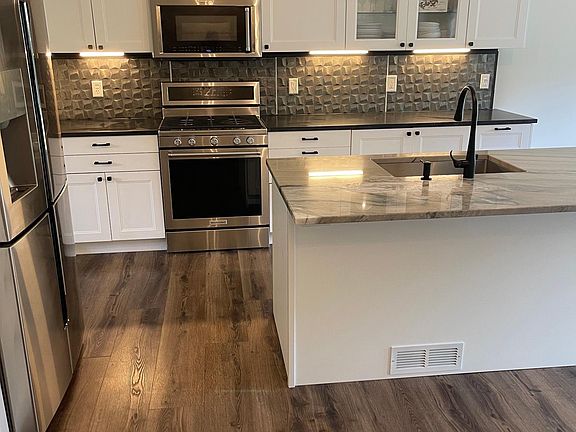 Chef's kitchen with high end appliances and plenty of cabinet space